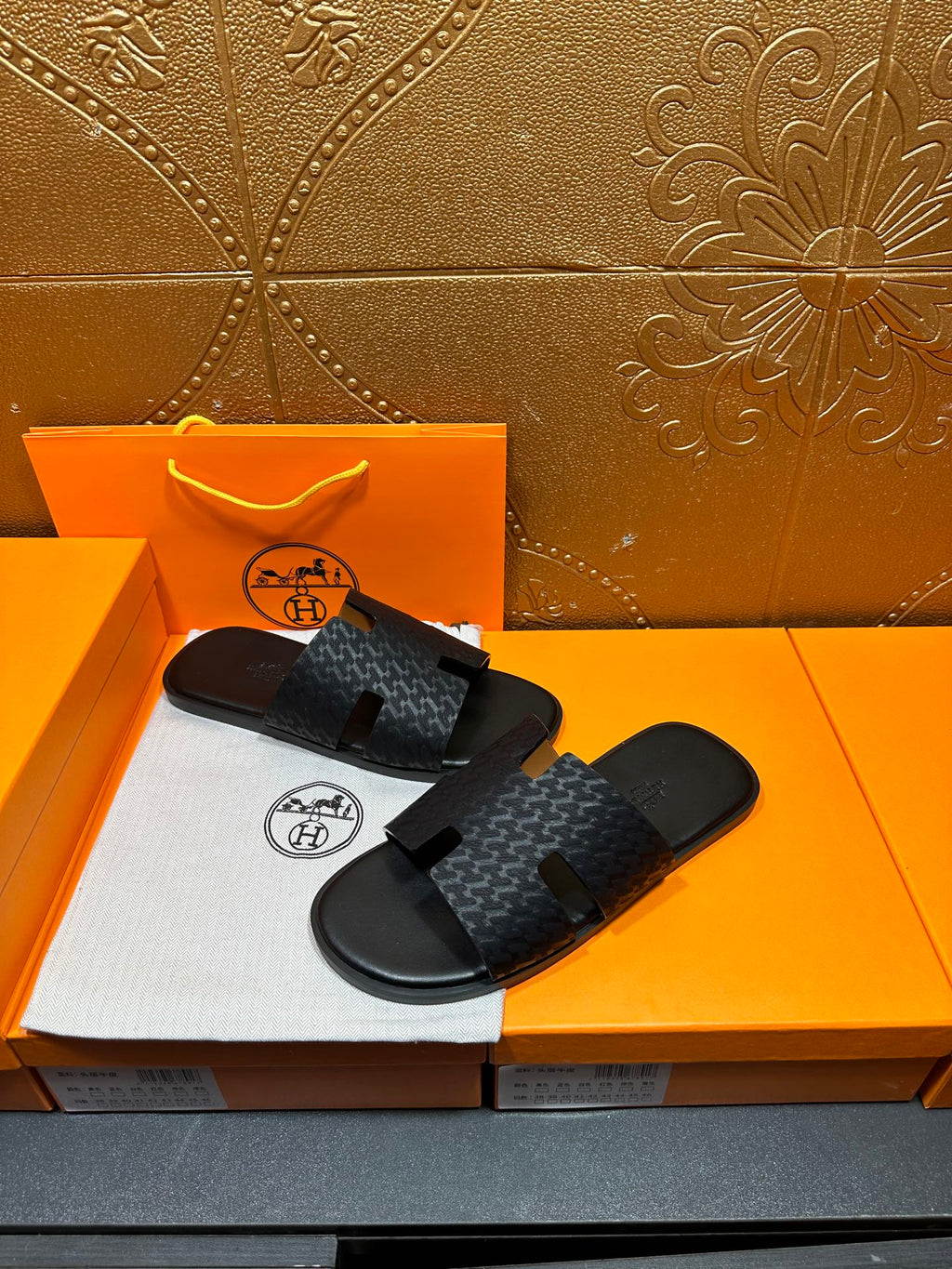 Hermes slide sandals: dark gray patterned upper with open toe and cutout strap