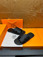 Hermes slide sandals: dark gray patterned upper with open toe and cutout strap