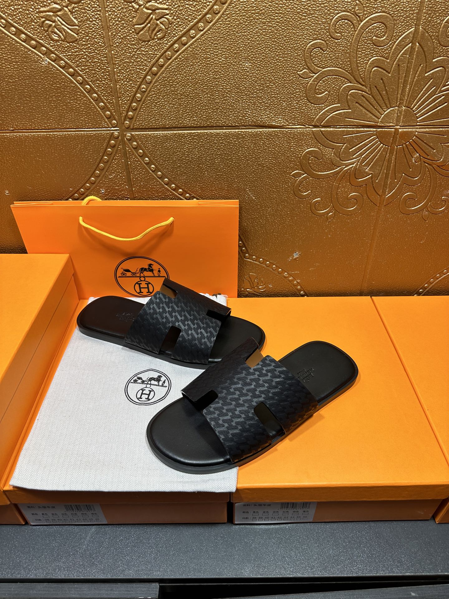 Hermes slide sandals: dark gray patterned upper with open toe and cutout strap