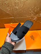 Hermes slide sandals on orange box: dark gray textured strap with open toe