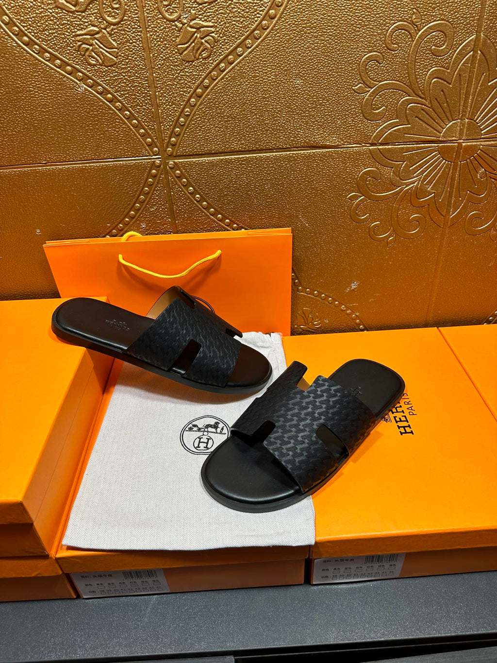 Hermes slide sandals with dark gray textured upper and black footbed