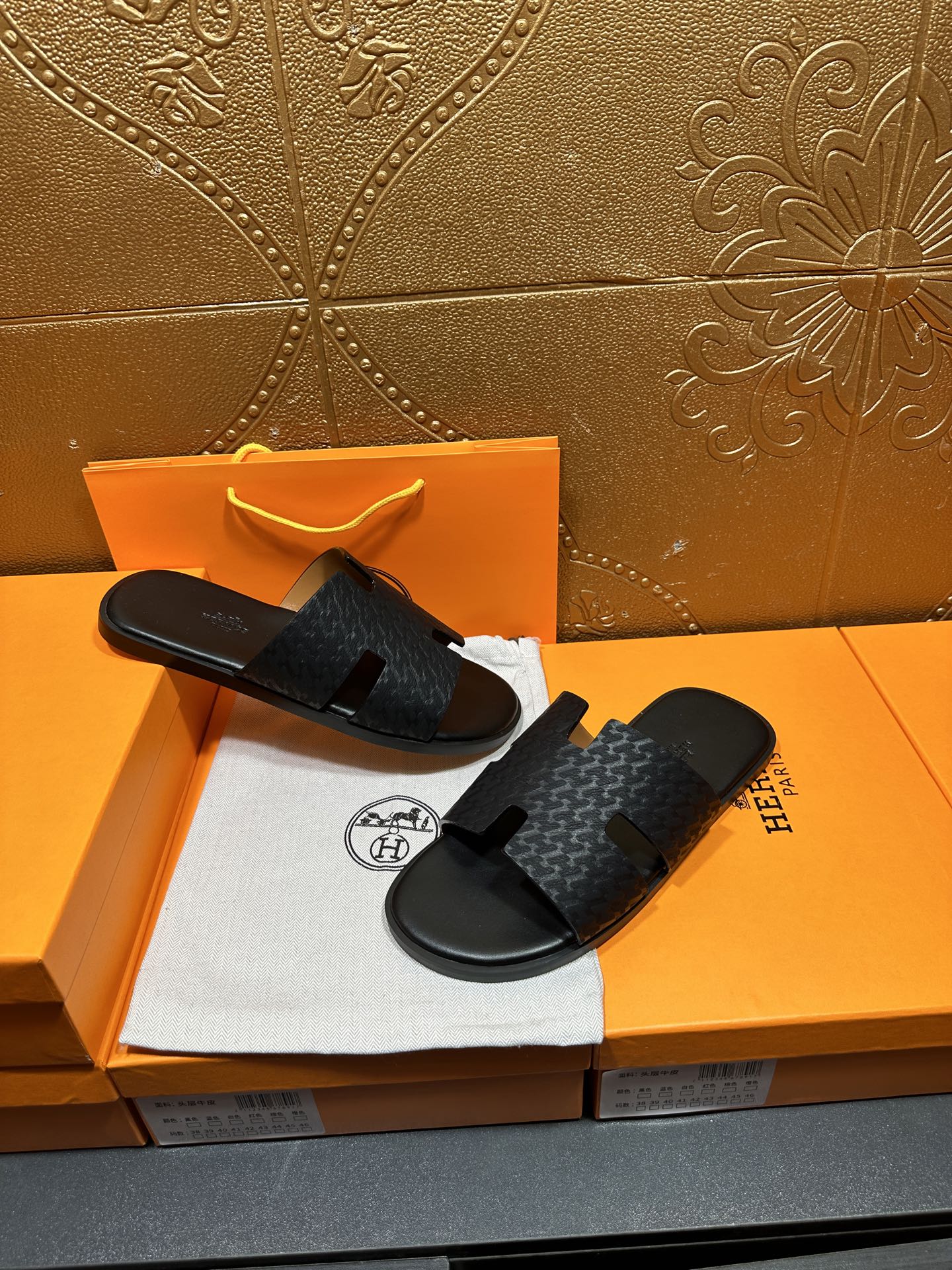 Hermes slide sandals with dark gray textured upper and black footbed