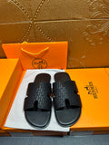 Hermes slide sandals in dark gray with textured strap and square cutout