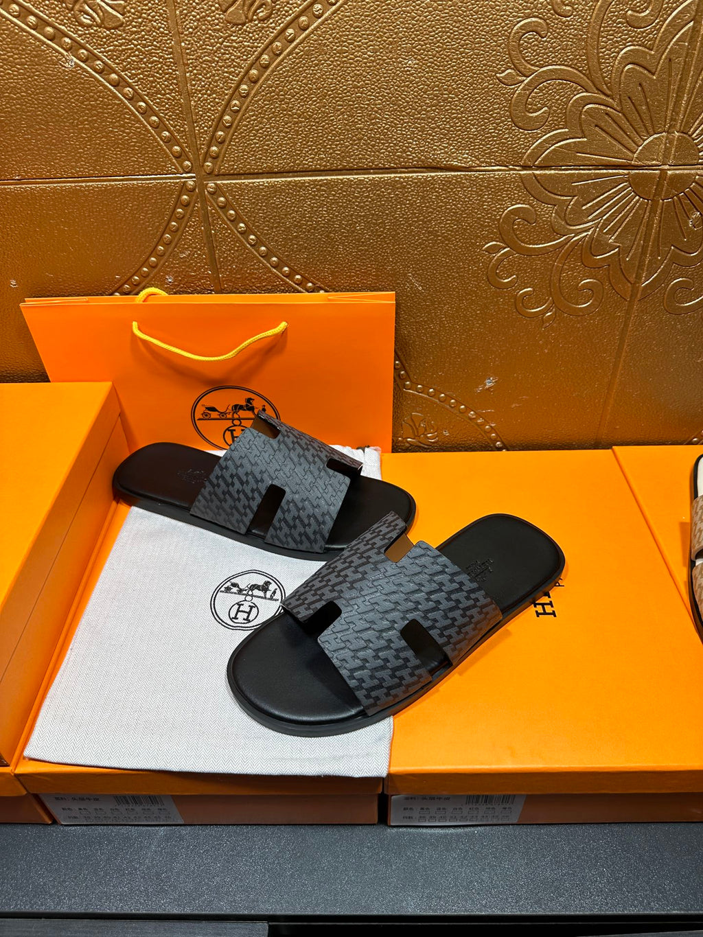Hermes slide sandals with charcoal textured strap and black wide toe band