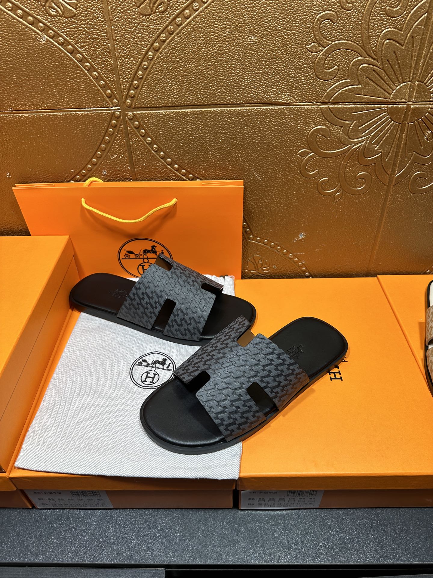 Hermes slide sandals with charcoal textured strap and black wide toe band
