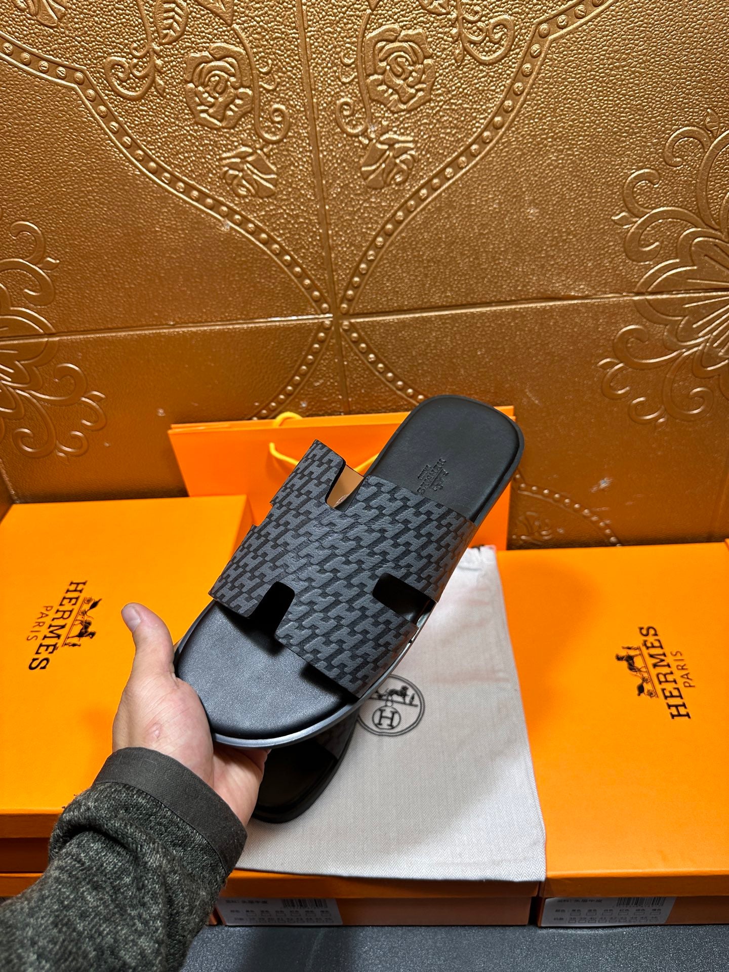 Hermes slide sandal held: charcoal patterned band strap with black rubber footbed