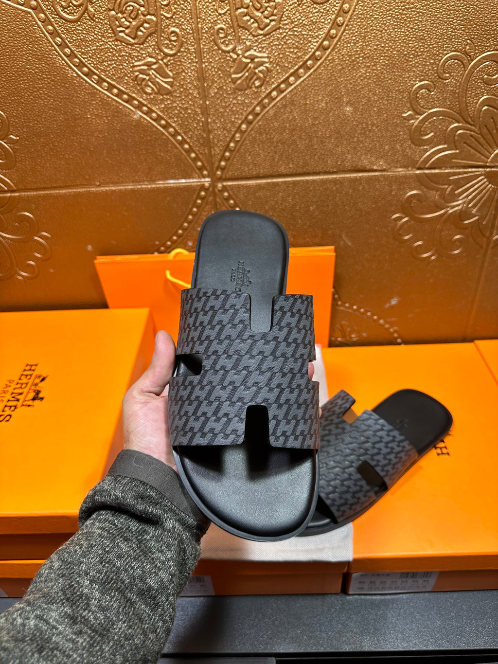 Hermes single charcoal slide sandal with patterned strap and black outsole