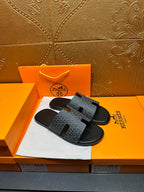 Hermes slide sandals with charcoal logo-pattern straps and black adjustable H cutouts