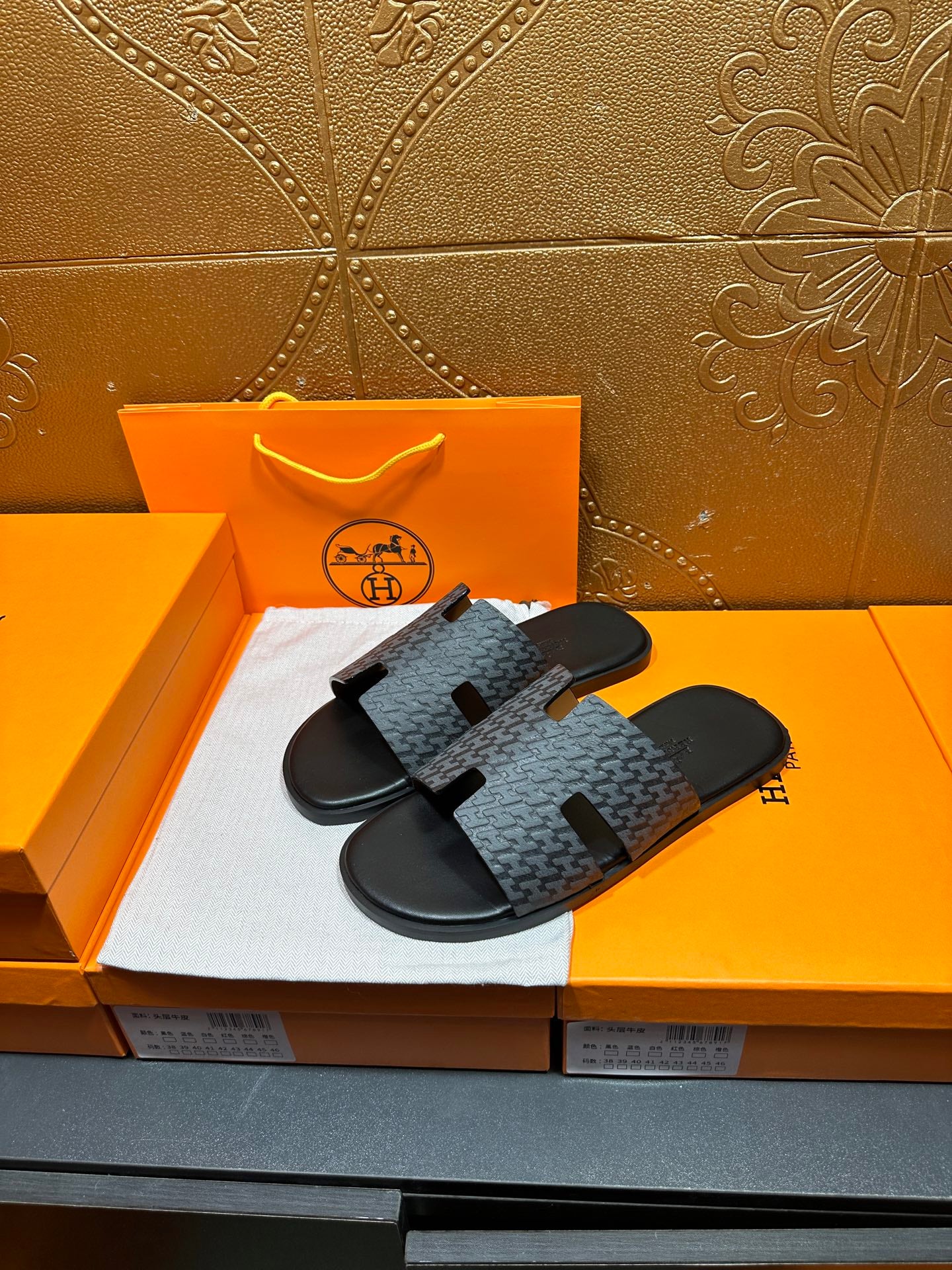 Hermes slide sandals, charcoal patterned band straps over black rubber soles