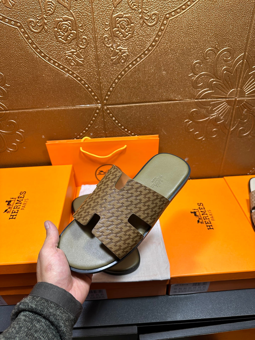 Hermes slide sandals with dark patterned slide straps and light gray footbeds
