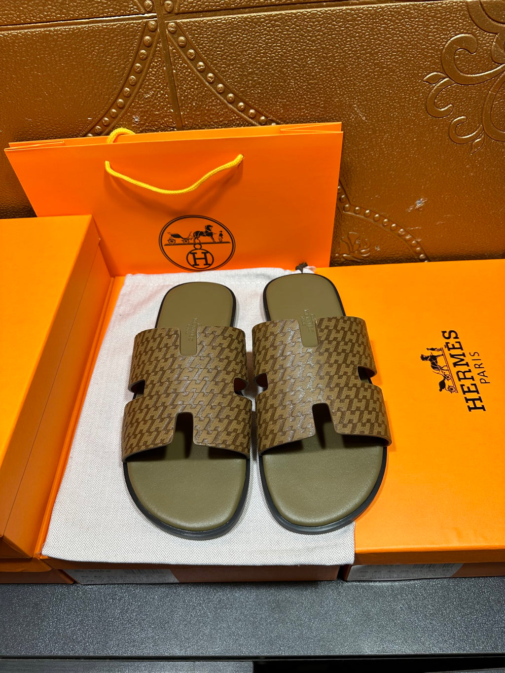 Hermes slide sandals with dark patterned straps and gray footbeds
