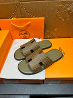 Hermes slide sandals, patterned upper with cutout strap details, gray footbeds