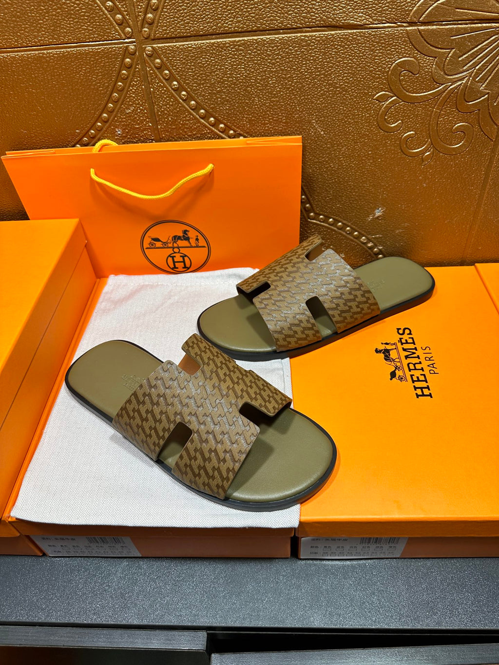Hermes slide sandals, patterned straps over gray contoured footbeds
