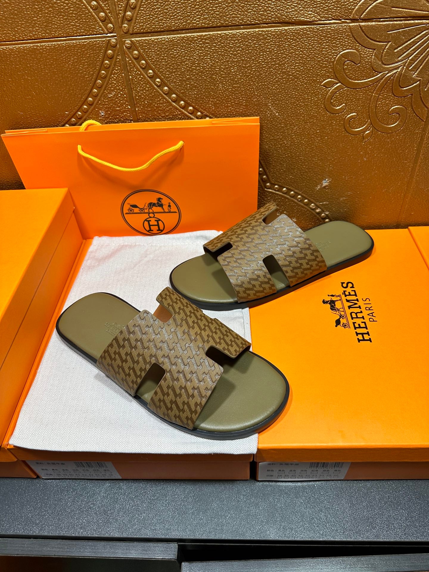 Hermes slide sandals, patterned straps over gray contoured footbeds
