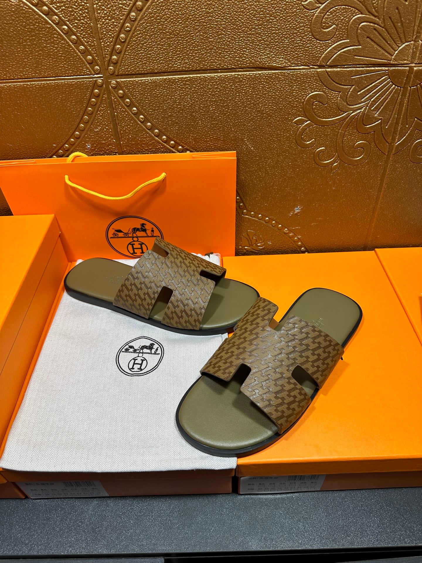 Hermes slide sandals, dark patterned straps on light gray molded footbeds