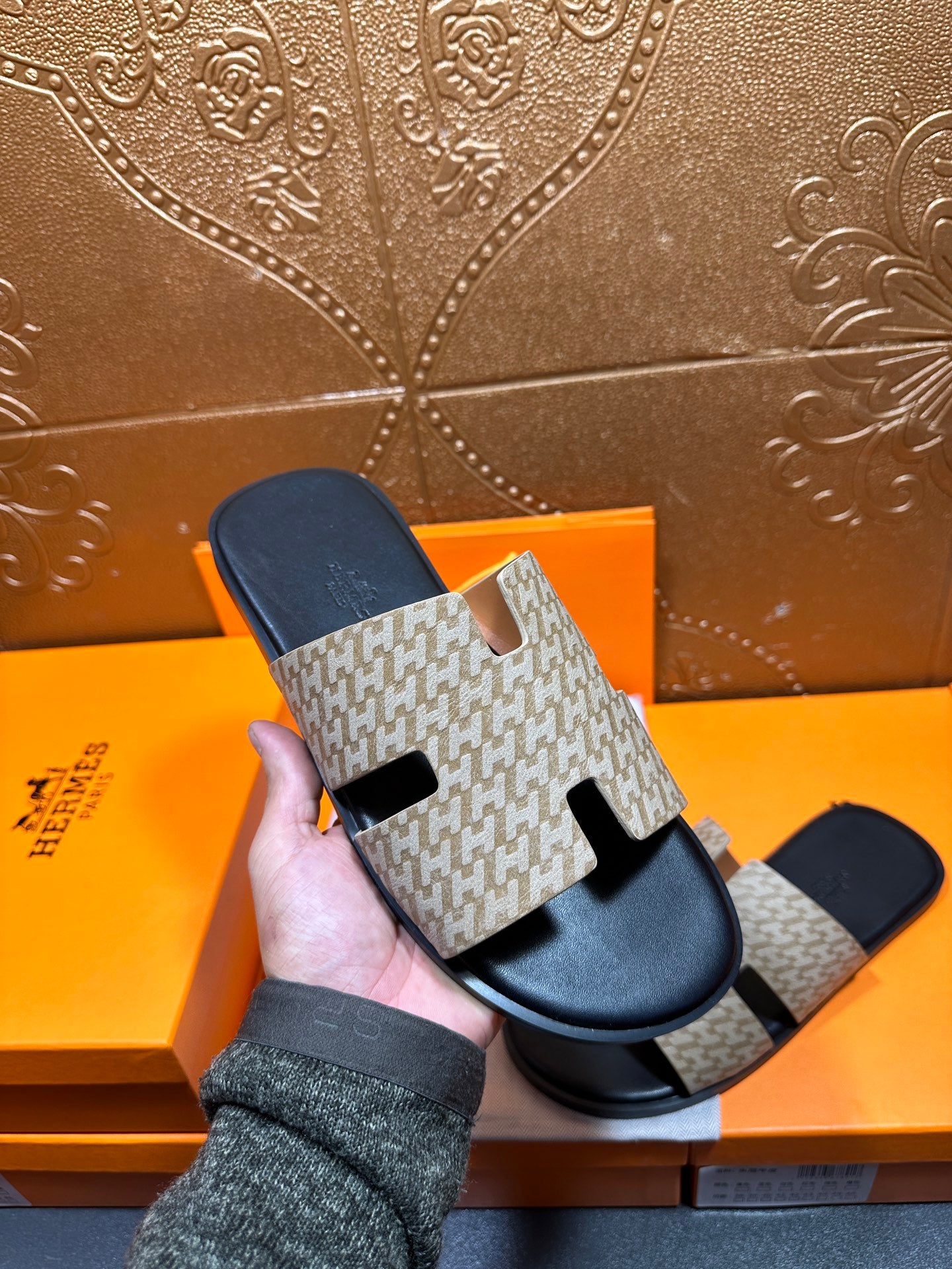 Beige patterned slide sandal with black footbed and adjustable-looking top strap