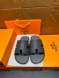 Hermes slide sandals in dark patterned fabric with black rubber footbeds and H-style straps