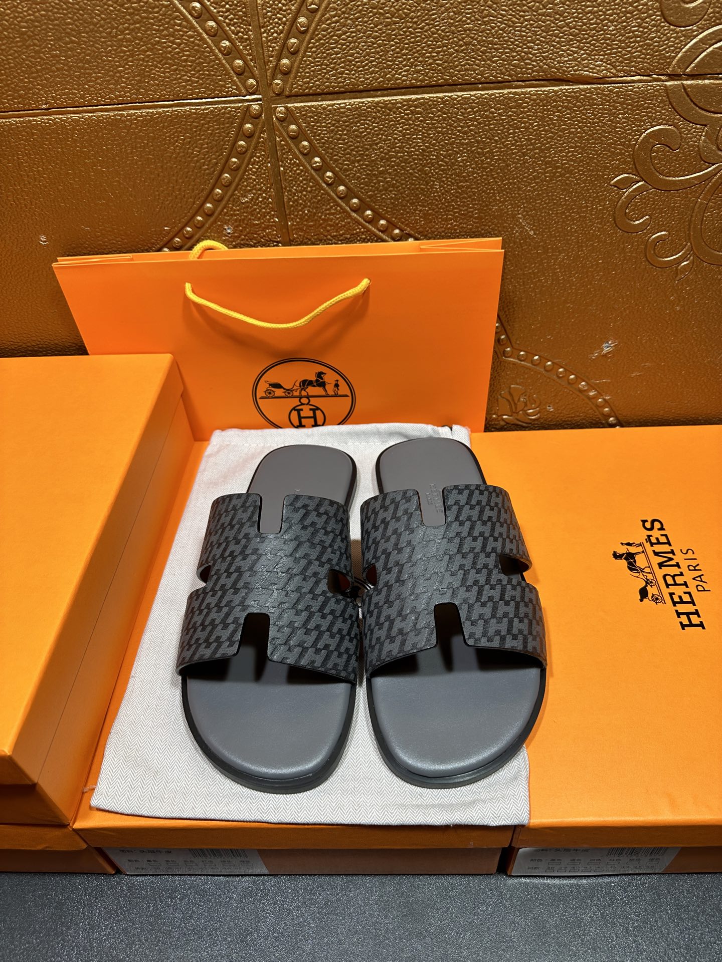 Hermes slide sandals in dark patterned fabric with black rubber footbeds and H-style straps