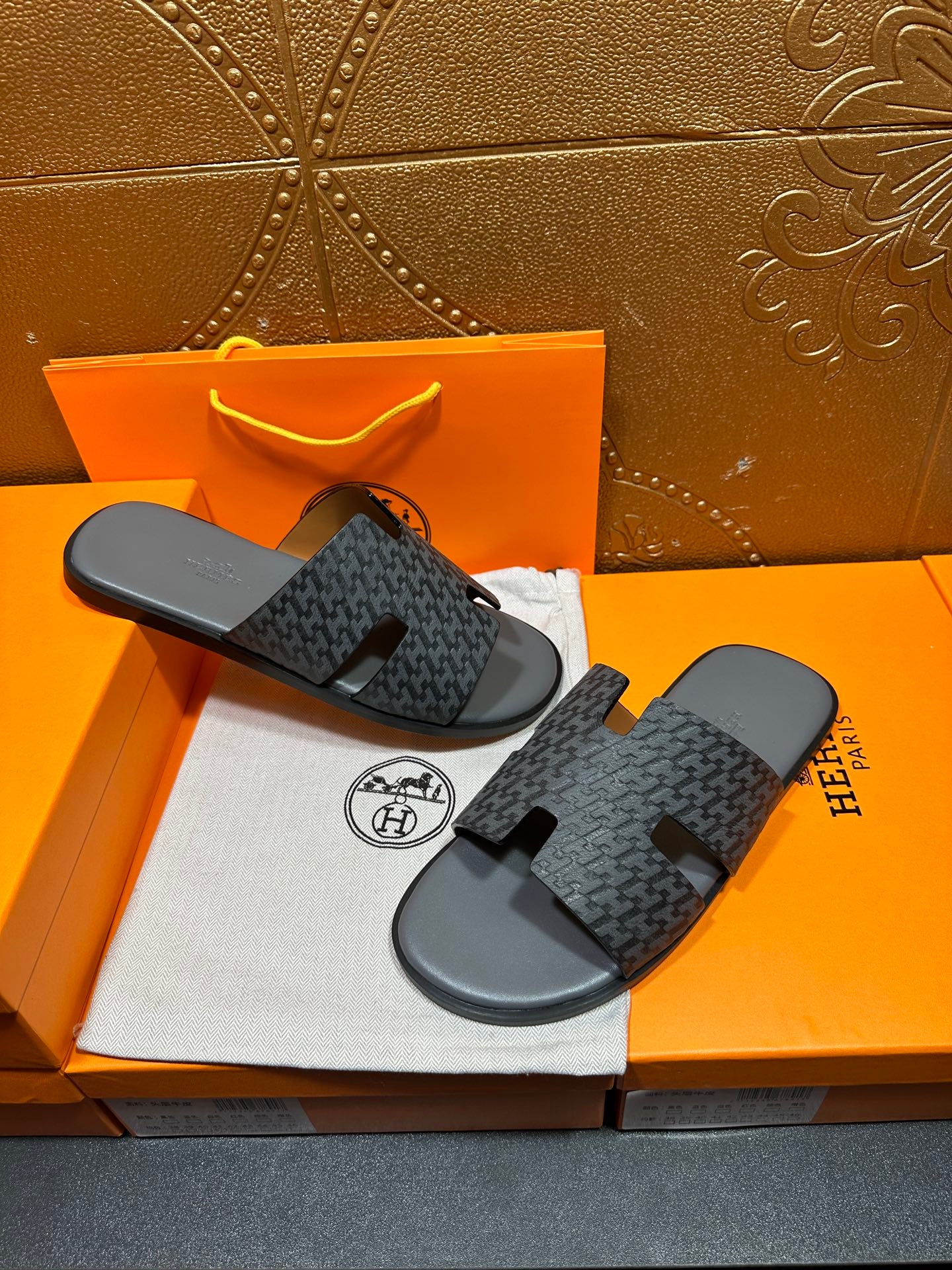 Hermes slide sandals, pair view, dark patterned fabric straps on black rubber soles