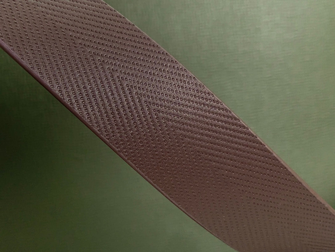 Olive green tote bag strap detail in textured material with brown edge