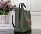 Olive green Louis Vuitton tote bag, side view with handles and logo