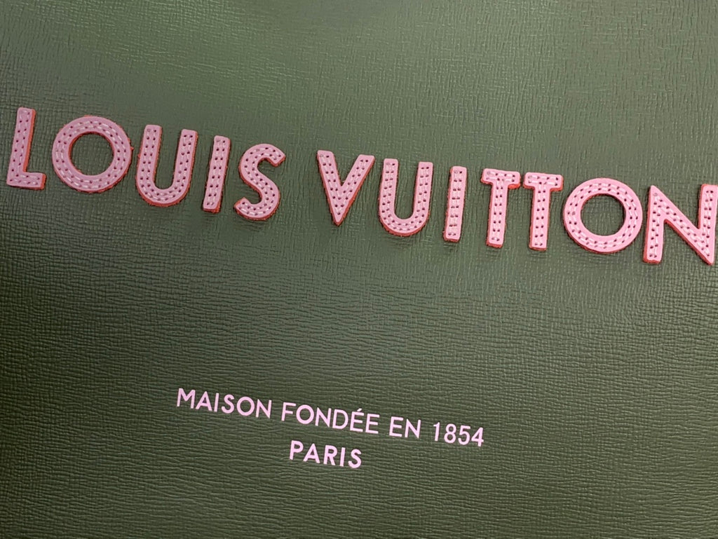 Olive green Louis Vuitton tote fabric with pink logo lettering and text