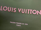 Olive green Louis Vuitton tote fabric with pink logo lettering and text