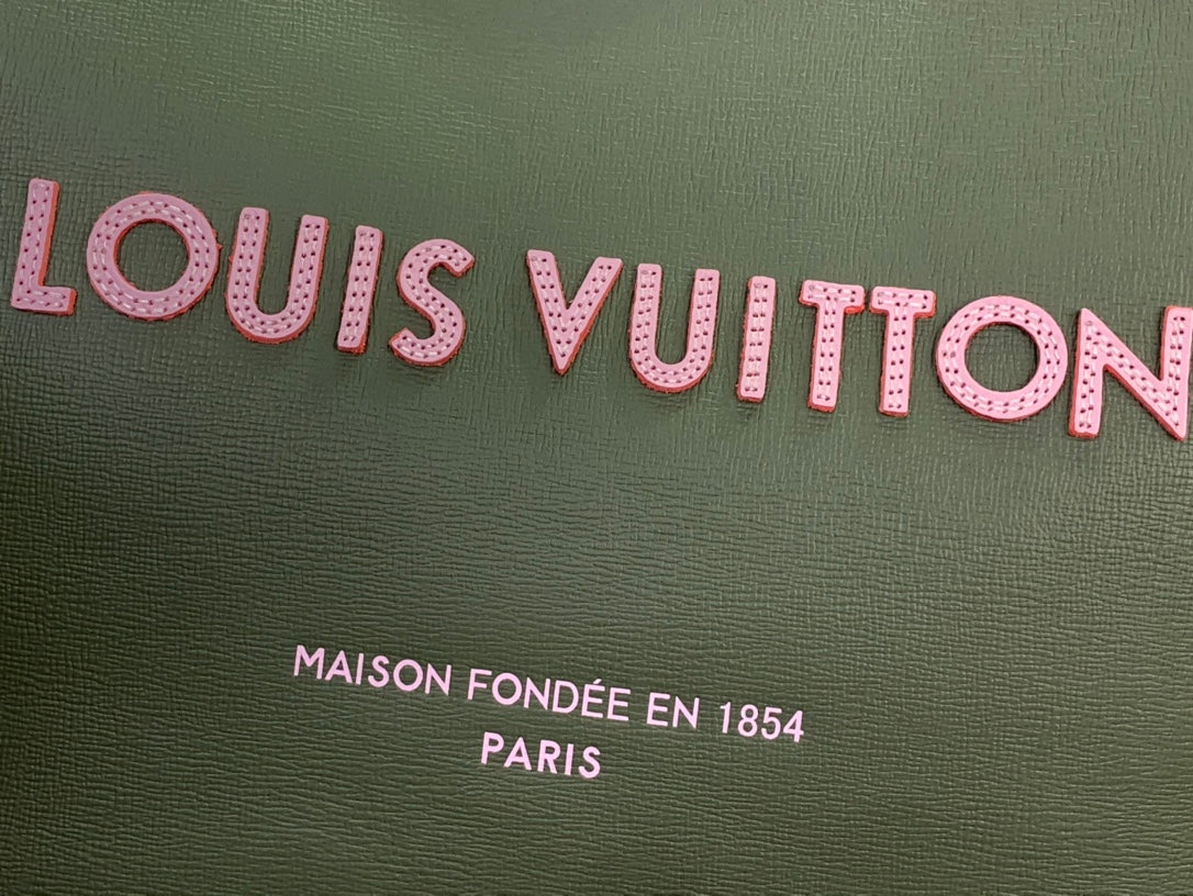 Olive green Louis Vuitton tote fabric with pink logo lettering and text