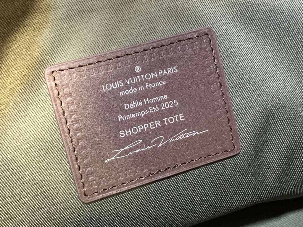 Leather Louis Vuitton tote label with stitched edges and printed text