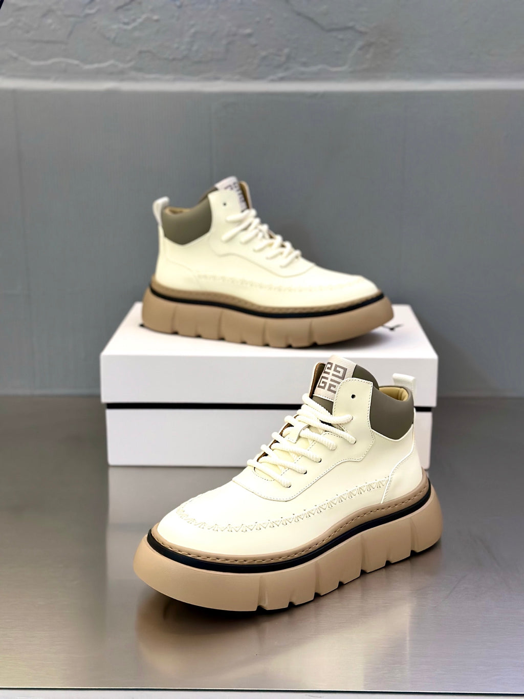Givenchy off-white sneakers with lace-up front and side branding on tongue
