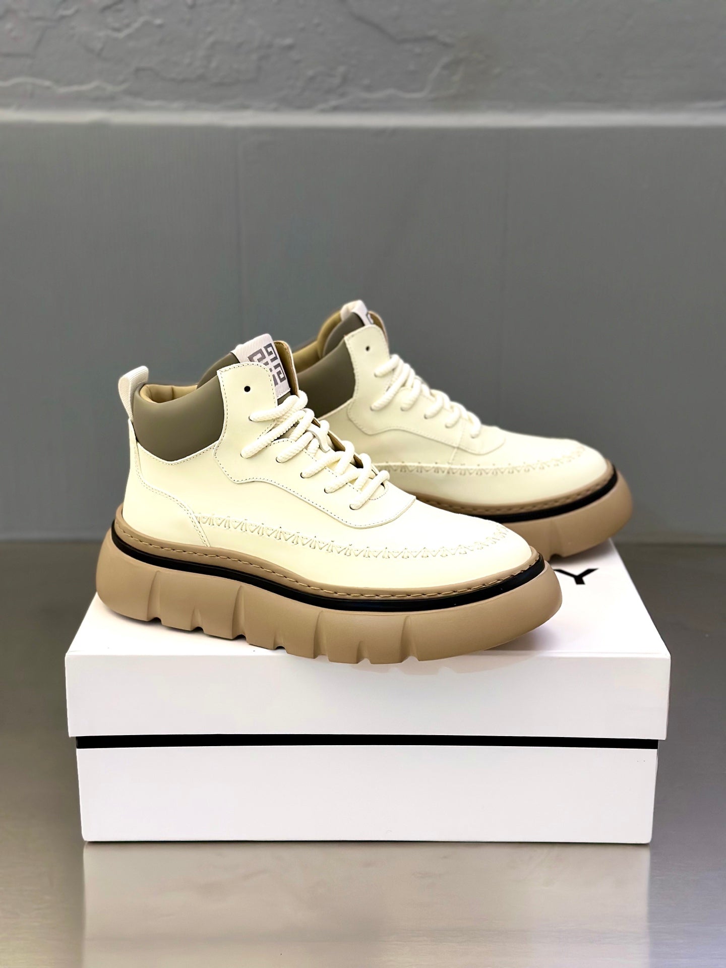 Givenchy pair of off-white sneakers on a box, lace-up style with padded tongue