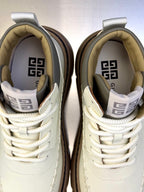 Givenchy sneakers close-up: off-white uppers with laces and logo-lined interior
