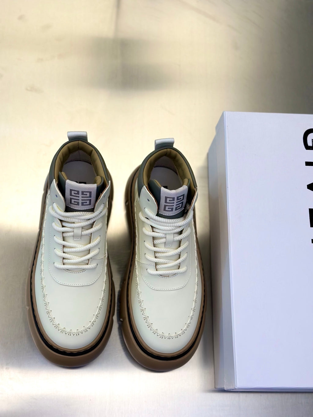 Givenchy lace-up sneakers in off-white with thick tan rubber sole and side stitching