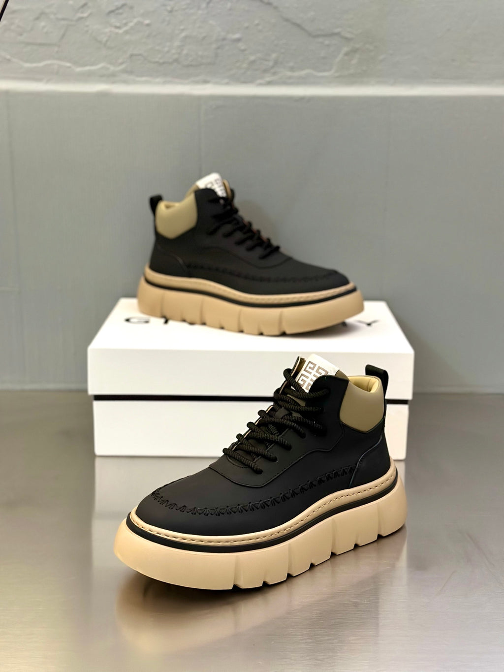 Dark navy lace-up sneakers with light beige ankle panels and platform sole