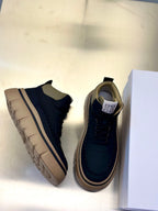Dark navy and beige lace-up sneakers, showing side profile and platform sole