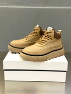 Beige pair of lace-up sneakers with chunky sole and G logo on tongue