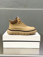 Beige lace-up sneakers on white box, rounded toe, chunky rubber sole
