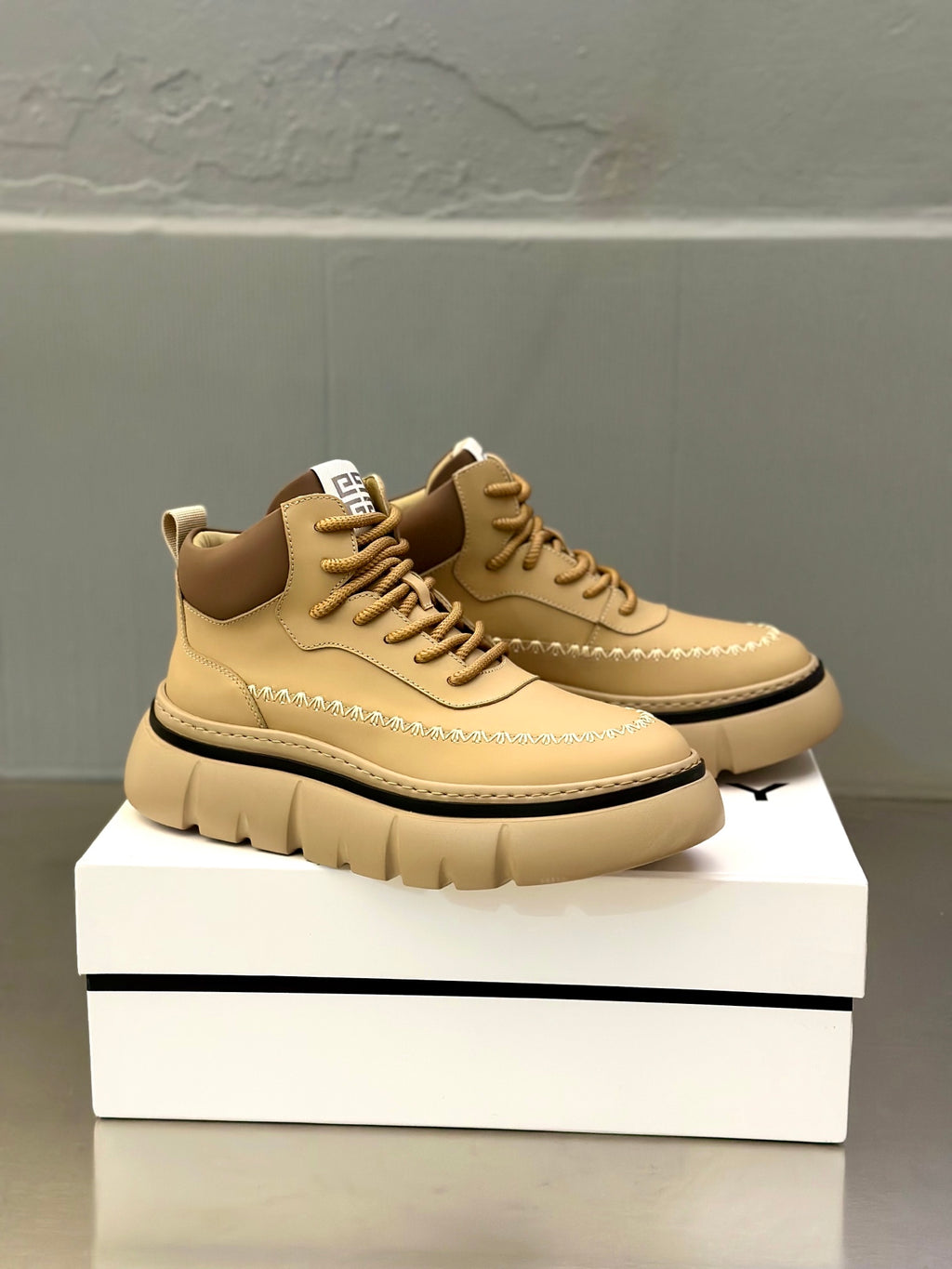 Beige leather lace-up sneakers with contrast heel tab and stitched edge detail