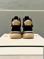 Back view of black and beige lace-up sneakers with heel strap and padded collar.