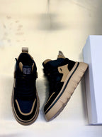 Black and beige lace-up sneakers pair, showing side profiles and lace-up uppers.