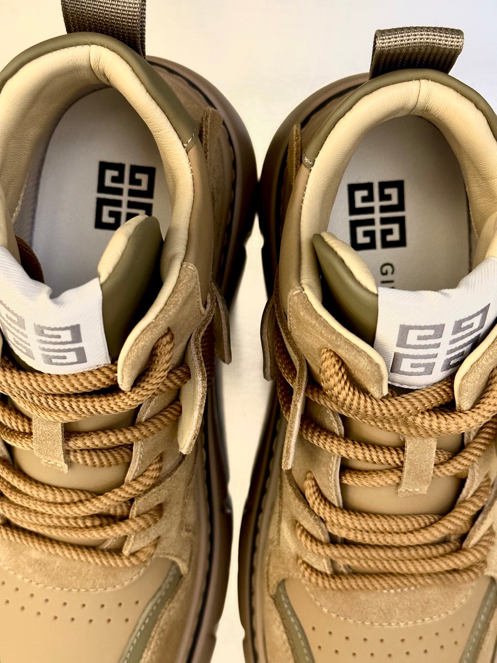 Givenchy sneakers close-up: tan uppers with lace-up ties and logo heel lining