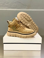 Olive-brown suede sneakers showing outsole tread detail and rear side paneling.