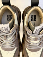 Close-up of sneaker tongue and collar with patterned logo lining and cream laces