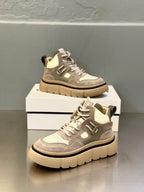 Gray and white lace-up sneakers with beige midsoles shown from side and top angles