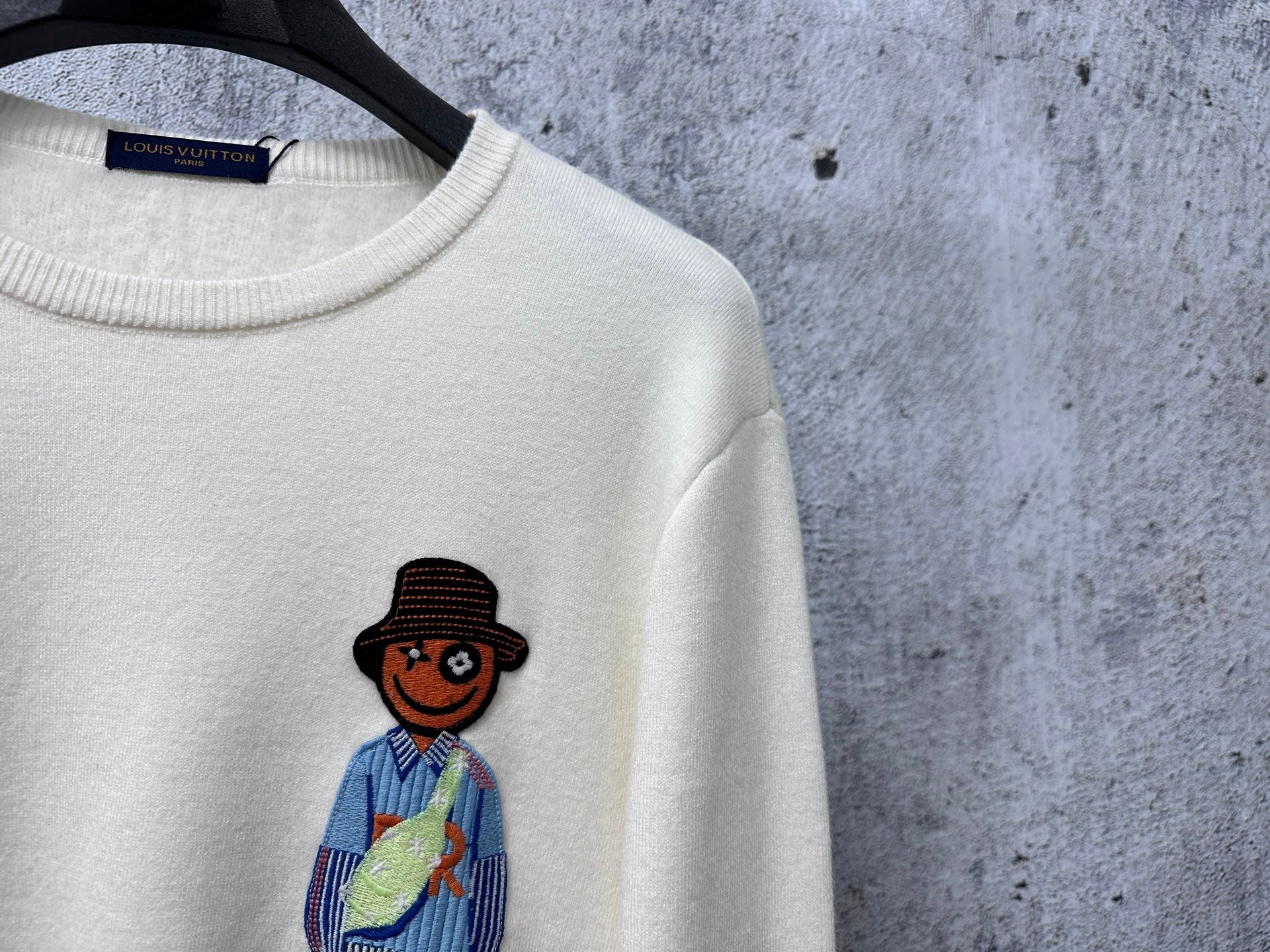 Louis Vuitton crewneck sweater detail, white knit with cartoon sailor graphic
