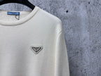 Prada cream sweater with small triangle PRADA logo at upper left chest