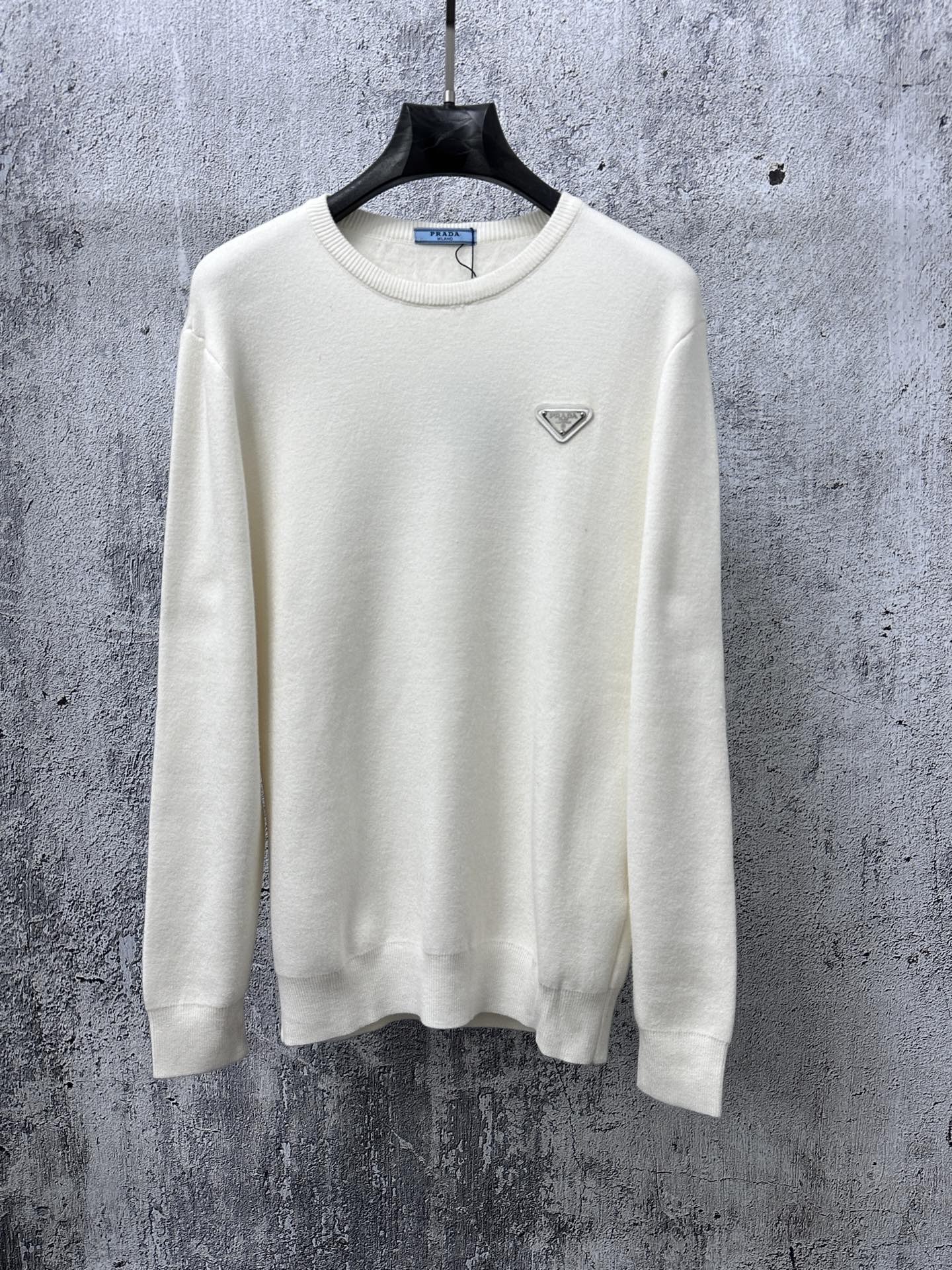 Prada cream long-sleeve sweater with crewneck and small triangle logo on chest