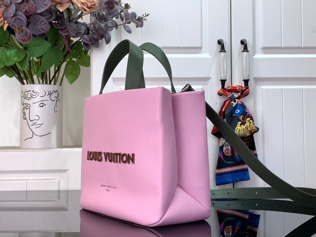 Louis Vuitton pink tote bag with green shoulder strap and front logo