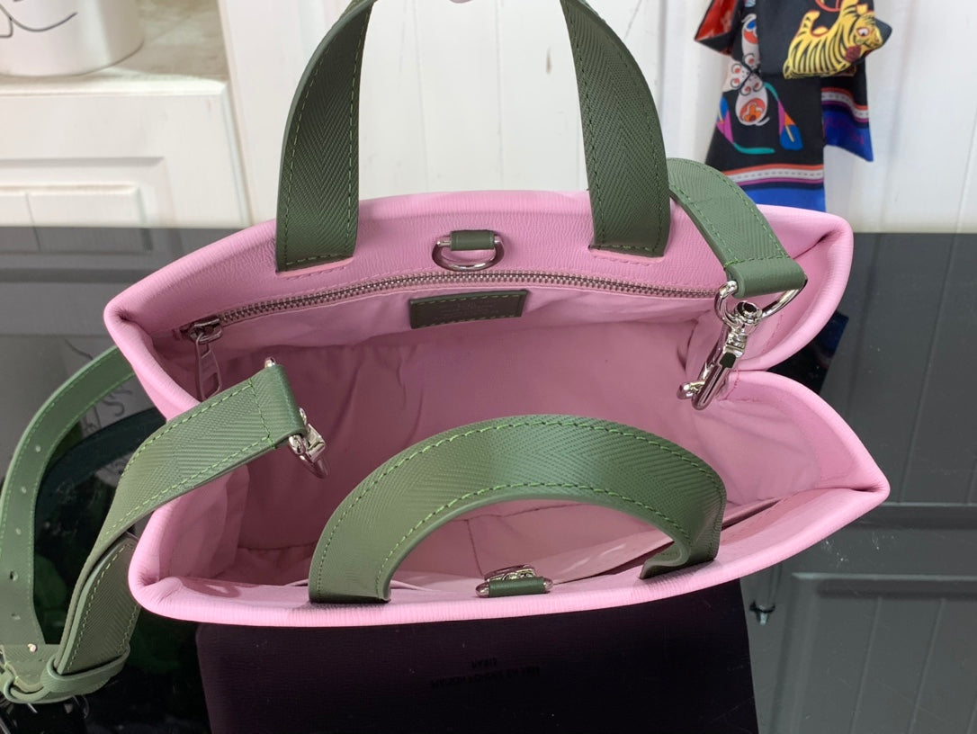 Louis Vuitton pink bag open with green interior and side pocket, green handles