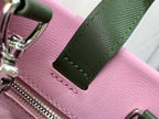 Louis Vuitton pink leather bag with green trim, stitch line, and zipper hardware